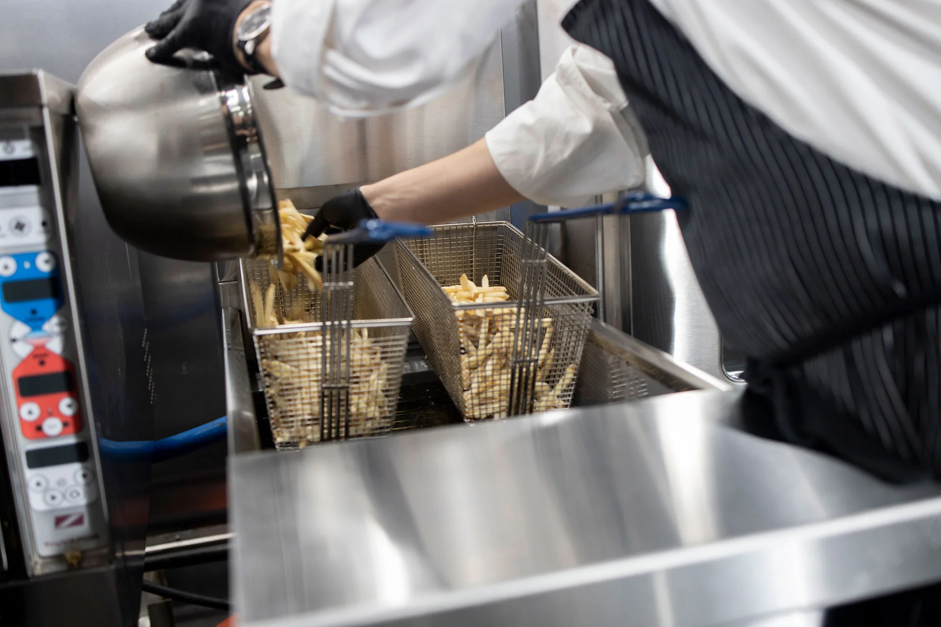 Filling a Fry Basket with French Fries